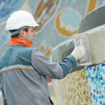 Industrial,Tiler,Builder,Worker,Installing,Floor,Tile,At,Repair,Renovation